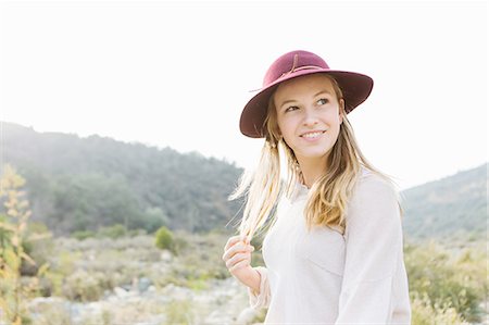 Portrait of young woman, smiling, outdoors Photographie de stock - Premium Libres de Droits, Code: 614-08392355