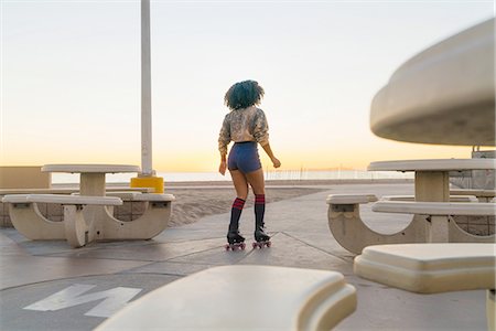 simsearch:614-08392515,k - Mid adult woman on rollerskates, near beach, rear view Stock Photo - Premium Royalty-Free, Code: 614-08392538