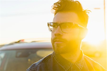 eyeglasses focus - Portrait of young man, outdoors, bright sunlight Stock Photo - Premium Royalty-Free, Code: 614-08392530