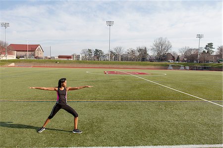 simsearch:614-06116401,k - Young woman standing on sports field in yoga position Stock Photo - Premium Royalty-Free, Code: 614-08392642