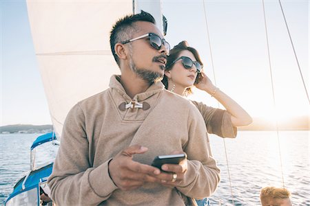 simsearch:614-08392689,k - Couple enjoying view on sailboat, San Diego Bay, California, USA Stock Photo - Premium Royalty-Free, Code: 614-08392669
