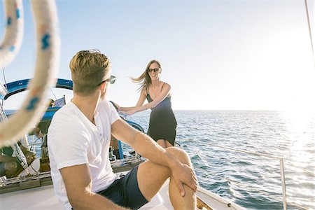 simsearch:614-08392689,k - Couple chatting on sailboat, San Diego Bay, California, USA Stock Photo - Premium Royalty-Free, Code: 614-08392675