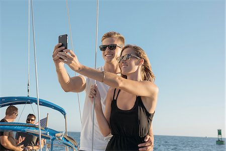 simsearch:614-08392689,k - Couple taking selfie on sailboat, San Diego Bay, California, USA Stock Photo - Premium Royalty-Free, Code: 614-08392673