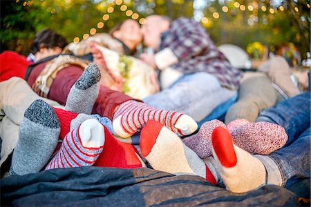 friendship feet - Entwined family socked feet lying on blanket in woods Stock Photo - Premium Royalty-Free, Code: 614-08392703