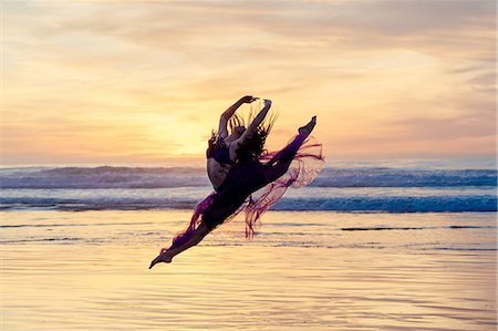 simsearch:614-06974601,k - Young female dancer wearing chiffon dress, dancing, in mid air, on beach at sunset, San Diego, California, USA Stock Photo - Premium Royalty-Free, Code: 614-08487771