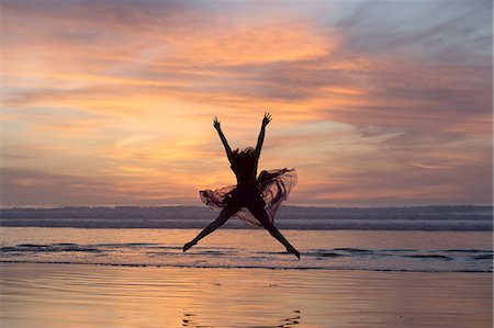 simsearch:614-06974601,k - Young female dancer wearing chiffon dress, dancing, in mid air, on beach at sunset, San Diego, California, USA Stock Photo - Premium Royalty-Free, Code: 614-08487773