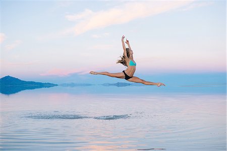 effortless - Female ballet dancer jumping mid air over lake, Bonneville Salt Flats, Utah, USA Stock Photo - Premium Royalty-Free, Code: 614-08487891