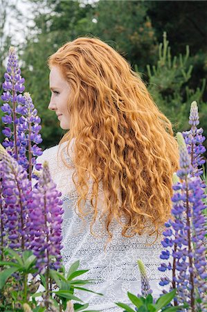 females in blouses - Rear view portrait  of young woman with long red hair  amongst purple wildflowers Stock Photo - Premium Royalty-Free, Code: 614-08487967
