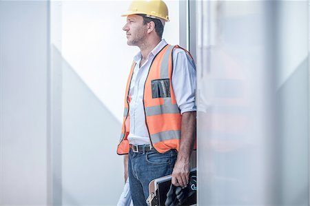 simsearch:614-06895837,k - Construction foreman looking out from doorway of portable cabin on construction site Stock Photo - Premium Royalty-Free, Code: 614-08488053
