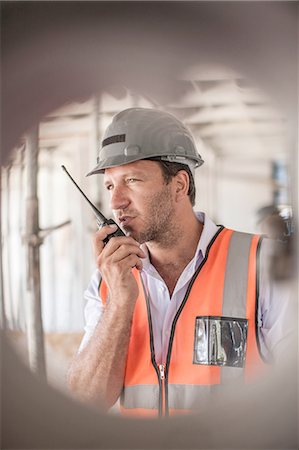 simsearch:614-06895837,k - Site manager using walkie talkie on construction site Stock Photo - Premium Royalty-Free, Code: 614-08488061