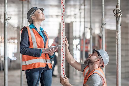 simsearch:614-00383197,k - Young male and female builders measuring construction with ruler Stock Photo - Premium Royalty-Free, Code: 614-08488079