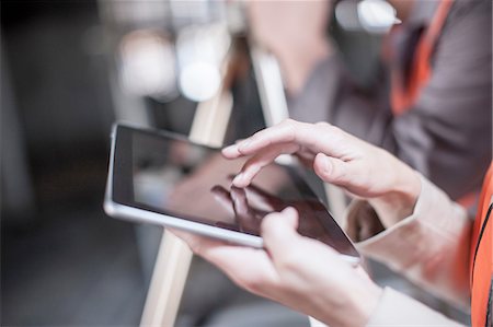 Close up of female surveyor using tablet touchscreen on construction site Stock Photo - Premium Royalty-Free, Code: 614-08488070