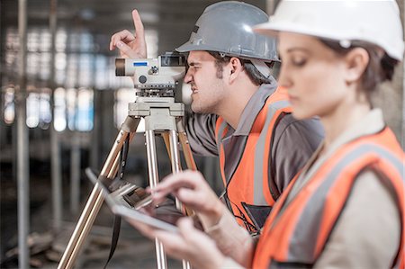 Female and male surveyor using digital tablet and theodolite  on construction site Stock Photo - Premium Royalty-Free, Code: 614-08488071