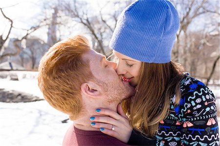 Romantic young couple kissing in snowy Central Park, New York, USA Stock Photo - Premium Royalty-Free, Code: 614-08535573