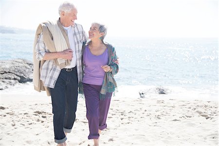 simsearch:614-09156788,k - Senior couple walking along beach, smiling Stock Photo - Premium Royalty-Free, Code: 614-08535636