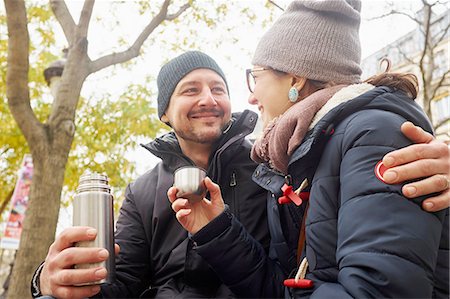 simsearch:614-08879491,k - Couple wearing knit hats holding drinks flask in park Stock Photo - Premium Royalty-Free, Code: 614-08535730