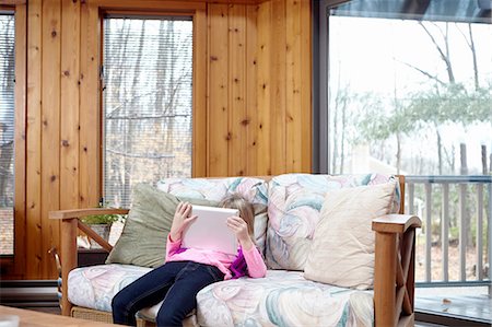 slumped over - Girl slouching on living room sofa using  digital tablet Stock Photo - Premium Royalty-Free, Code: 614-08535829