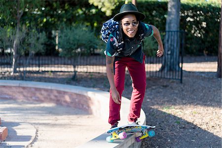 Woman skateboarding in park Stock Photo - Premium Royalty-Free, Code: 614-08535857