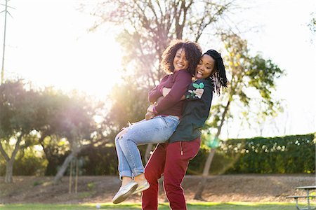 Lesbian couple fooling around in park, laughing Stock Photo - Premium Royalty-Free, Code: 614-08535862