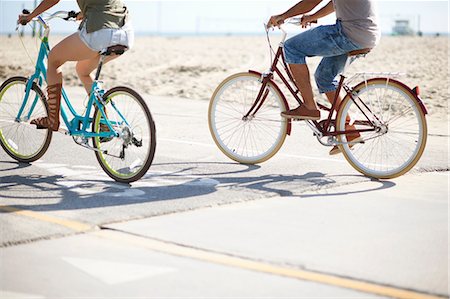 enroute - Neck down view of couple cycling at Venice Beach, Los Angeles, California, USA Stock Photo - Premium Royalty-Free, Code: 614-08544992