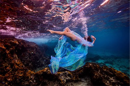 female underwater still - Woman underwater in ocean over coral reef Stock Photo - Premium Royalty-Free, Code: 614-08578258