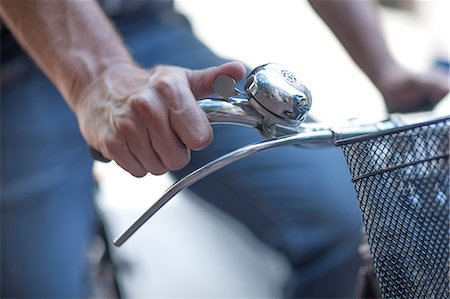 Cropped close up of male cyclists hand ringing cycle bell Stock Photo - Premium Royalty-Free, Code: 614-08578377