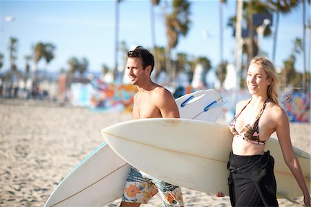 Surfing couple carrying surfboards on Venice Beach, California, USA Stock Photo - Premium Royalty-Free, Code: 614-08578382