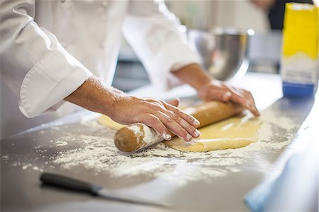 simsearch:614-08578561,k - Chef rolling out dough on table Stock Photo - Premium Royalty-Free, Code: 614-08578551