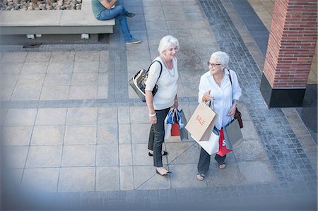 friends and shopping and happy - High angle view of mature women shoppers in shopping mall Stock Photo - Premium Royalty-Free, Code: 614-08578599