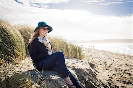 simsearch:614-08827383,k - Woman wearing felt hat and sunglasses sitting on dunes, Dillon Beach, California, USA Photographie de stock - Premium Libres de Droits, Code: 614-08578743