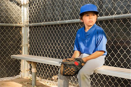 Boy watching from bench at baseball practise Stock Photo - Premium Royalty-Free, Code: 614-08578787