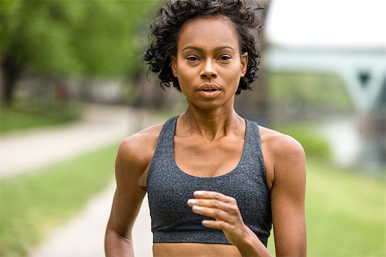 Portrait of woman wearing crop top jogging Stock Photo - Premium Royalty-Free, Image code: 614-08641269