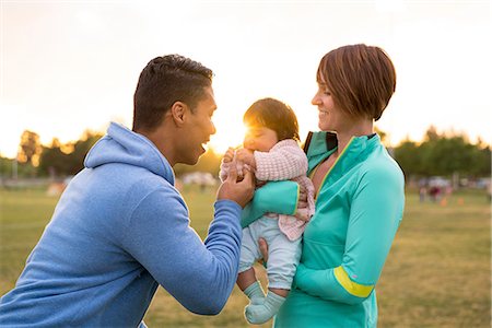 Couple playing with baby in park Stock Photo - Premium Royalty-Free, Code: 614-08641634