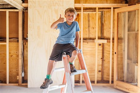 Portrait of cute boy sitting on top of a step ladder in unfinished room Stock Photo - Premium Royalty-Free, Code: 614-08641680