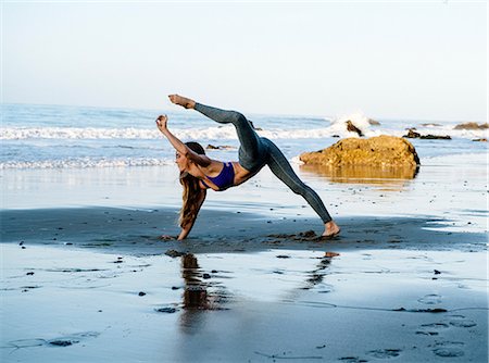 Young female dancer balancing on hand at beach, Los Angeles, California, USA Stock Photo - Premium Royalty-Free, Code: 614-08641705