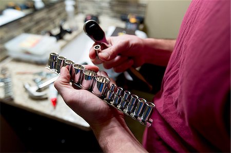 plumber working on side photos - Man's hands selecting socket wrench to repair bathroom Stock Photo - Premium Royalty-Free, Code: 614-08641729