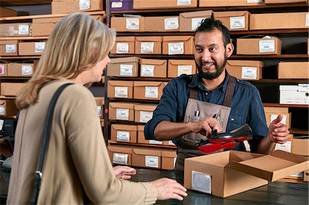 satisfacción - Female customer buying shoes in traditional shoe shop Stock Photo - Premium Royalty-Free, Code: 614-08641742