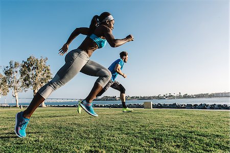 people wearing t shirts - Man and young woman training, sprinting on coast, downtown San Diego, California, USA Stock Photo - Premium Royalty-Free, Code: 614-08684939