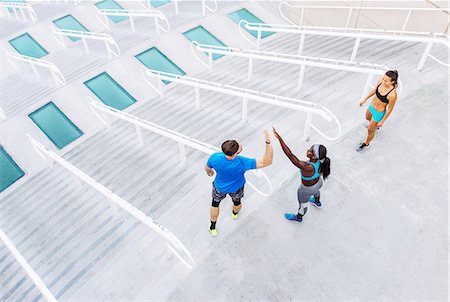 simsearch:614-08684939,k - High angle view of man and women training, high fiving on stairway at sport facility, downtown San Diego, California, USA Stock Photo - Premium Royalty-Free, Code: 614-08684952