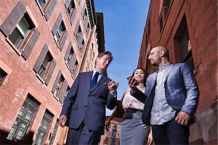 simsearch:614-09017513,k - Businessmen and women walking outdoors, low angle view Stock Photo - Premium Royalty-Free, Code: 614-08685172