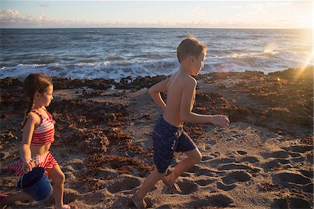 swimming suits for 12 years old girls - Boy and sister running on beach, Blowing Rocks Preserve, Jupiter Island, Florida, USA Stock Photo - Premium Royalty-Free, Code: 614-08685204