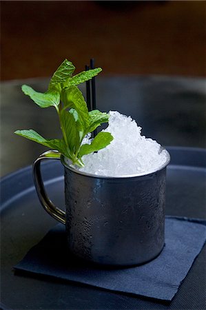 Mojito cocktail in tin cup with sprig of mint, close-up Stock Photo - Premium Royalty-Free, Code: 614-08726429