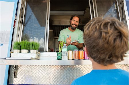 simsearch:614-08726534,k - Man in fast food trailer serving young boy through hatch Stock Photo - Premium Royalty-Free, Code: 614-08726520