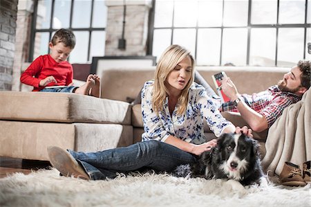 family indoors pet - Couple and son relaxing with dog at home Stock Photo - Premium Royalty-Free, Code: 614-08726581