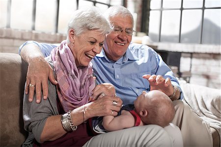 seniors and babies - Grandparents playing with granddaughter at home Stock Photo - Premium Royalty-Free, Code: 614-08726591