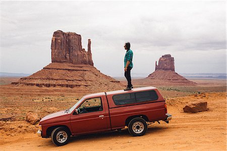 road trip in arizona - Young man looking out from top of four wheel drive, Monument Valley, Arizona, USA Stock Photo - Premium Royalty-Free, Code: 614-08726756