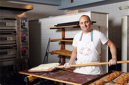 Baker working in bakery Stock Photo - Premium Royalty-Free, Code: 614-08720512