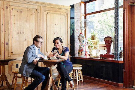 simsearch:614-08720540,k - Man and woman sitting in cafe drinking coffee, looking at smartphone Stockbilder - Premium RF Lizenzfrei, Bildnummer: 614-08720541