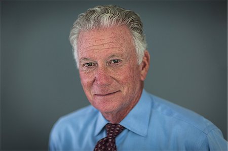 Head and shoulder portrait of grey haired senior businessman Stock Photo - Premium Royalty-Free, Code: 614-08720580