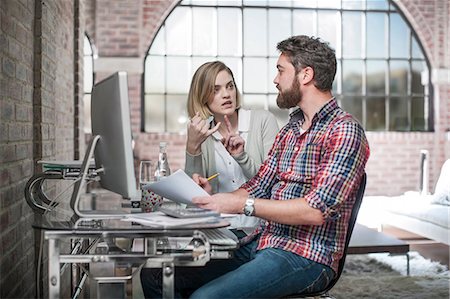 sad women paying bills - Couple at home, sitting at desk, using computer, having discussion, man holding paperwork Stock Photo - Premium Royalty-Free, Code: 614-08720596